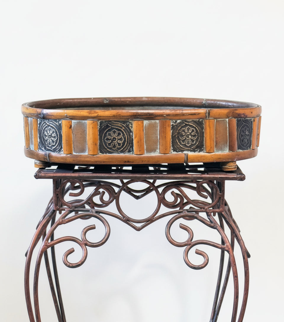 17 inch oval rattan container with detailed edge on a decorative metal stand for illustration purposes