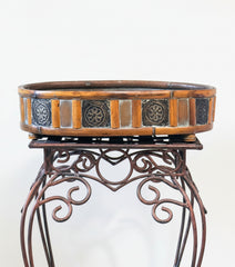 17 inch oval rattan container with detailed edge on a decorative metal stand for illustration purposes