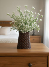 artificial dandelion plant in metal vase on a dresser in a girls room