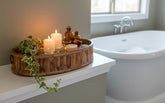 Set of 3 Oval Bamboo Serving Trays with Brass Rings containing an ivy, candles and other goodies in a bathroom