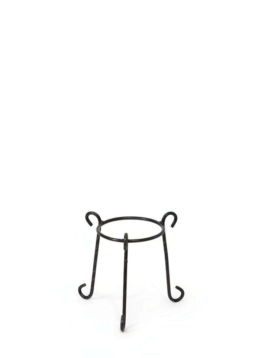 Small circular metal plant stand with curved legs for indoor décor