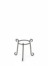 Small circular metal plant stand with curved legs for indoor décor