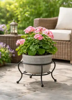 small decorative metal plant stand displaying a flowering plant