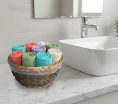12 inch basket with plastic liner used for colorful washcloths for guests.