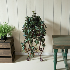 30" Artificial Pittsburgh Mini Leaf Trailing Ivy on a copper plant stand in a rustic country setting.