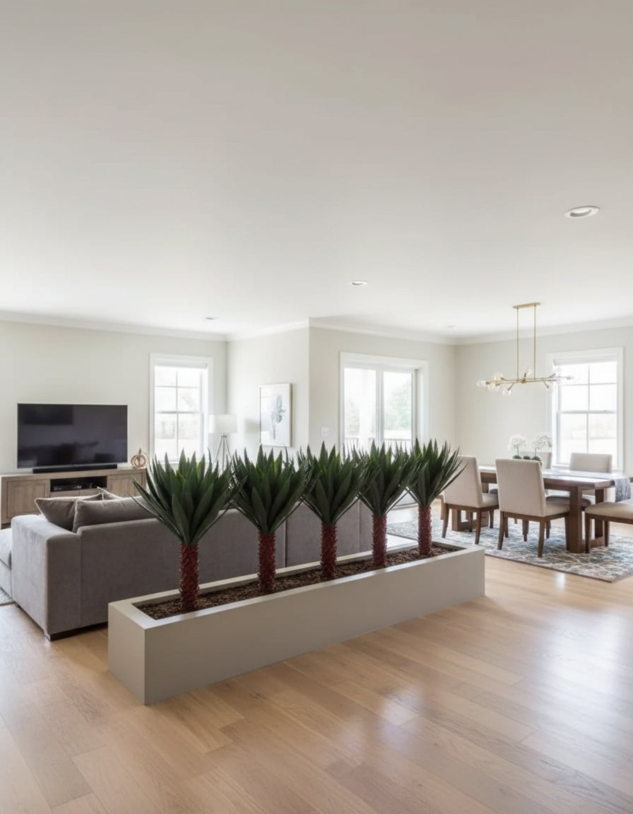 5 - 60 inch Artificial PVC Dracaena Plants in a planter that is dividing a family room from a dining room