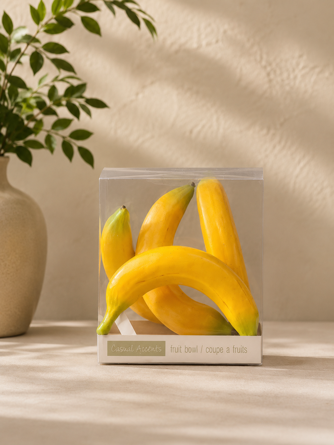 Set of 4 artificial bananas recently purchased on the counter ready to be placed in a bowl