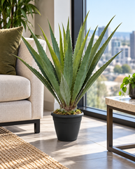 42 inch artificial PVC Agave in an included black pot on the floor beside seating in a condo rooftop indoor amenity lounge with large windows