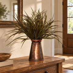 21-inch artificial sage green and brown grass arrangement in a riveted copper-tone container on a home entryway console.