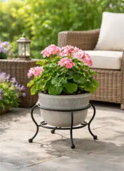 small decorative metal plant stand displaying a flowering plant